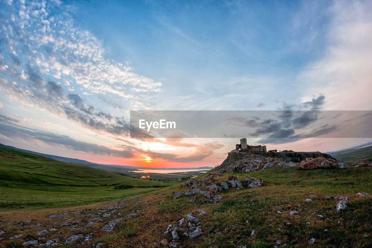 Scenic view of field against sky during sunset