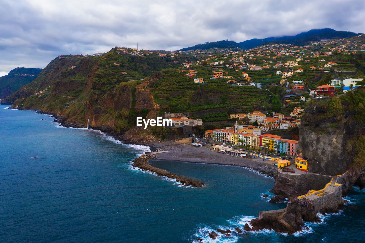 high angle view of sea and buildings against sky