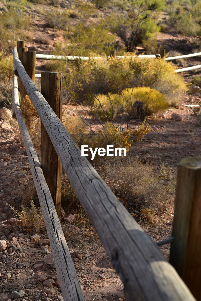 Rail fence in desert land receding perspective