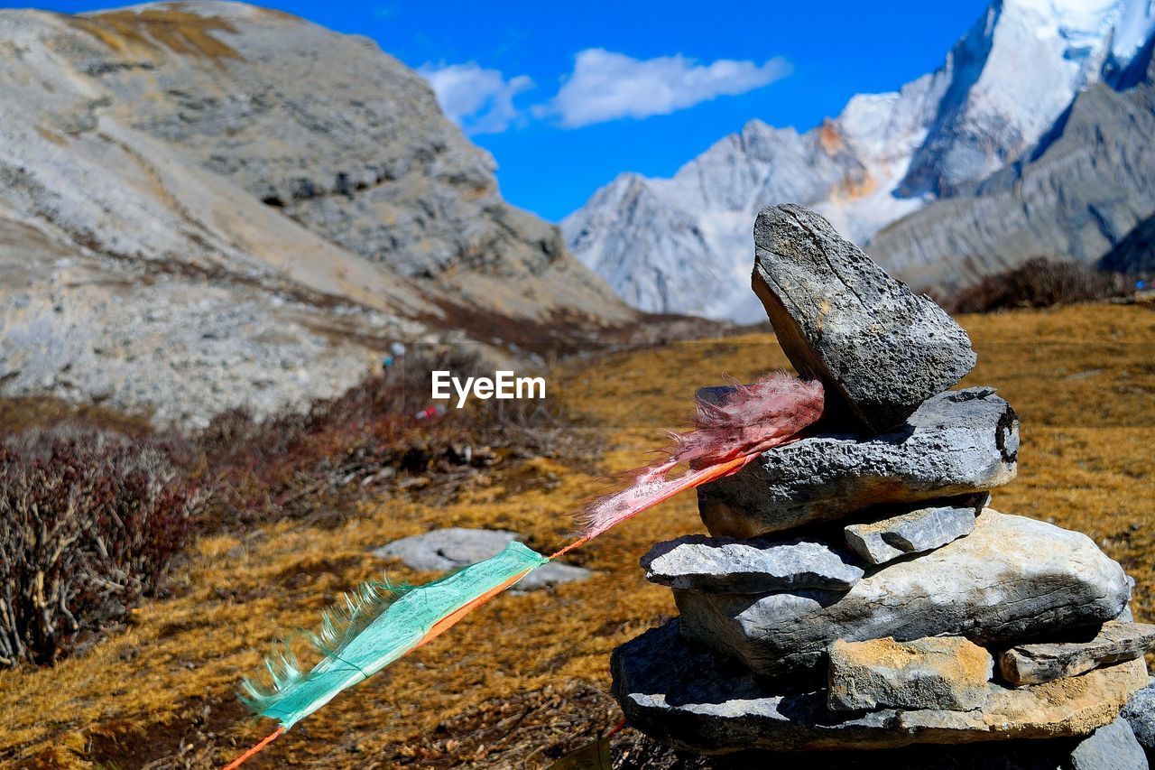 Stack of rocks on field on mountain