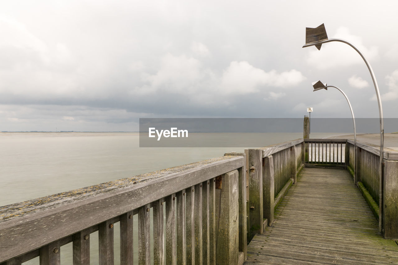 Pier over sea against sky