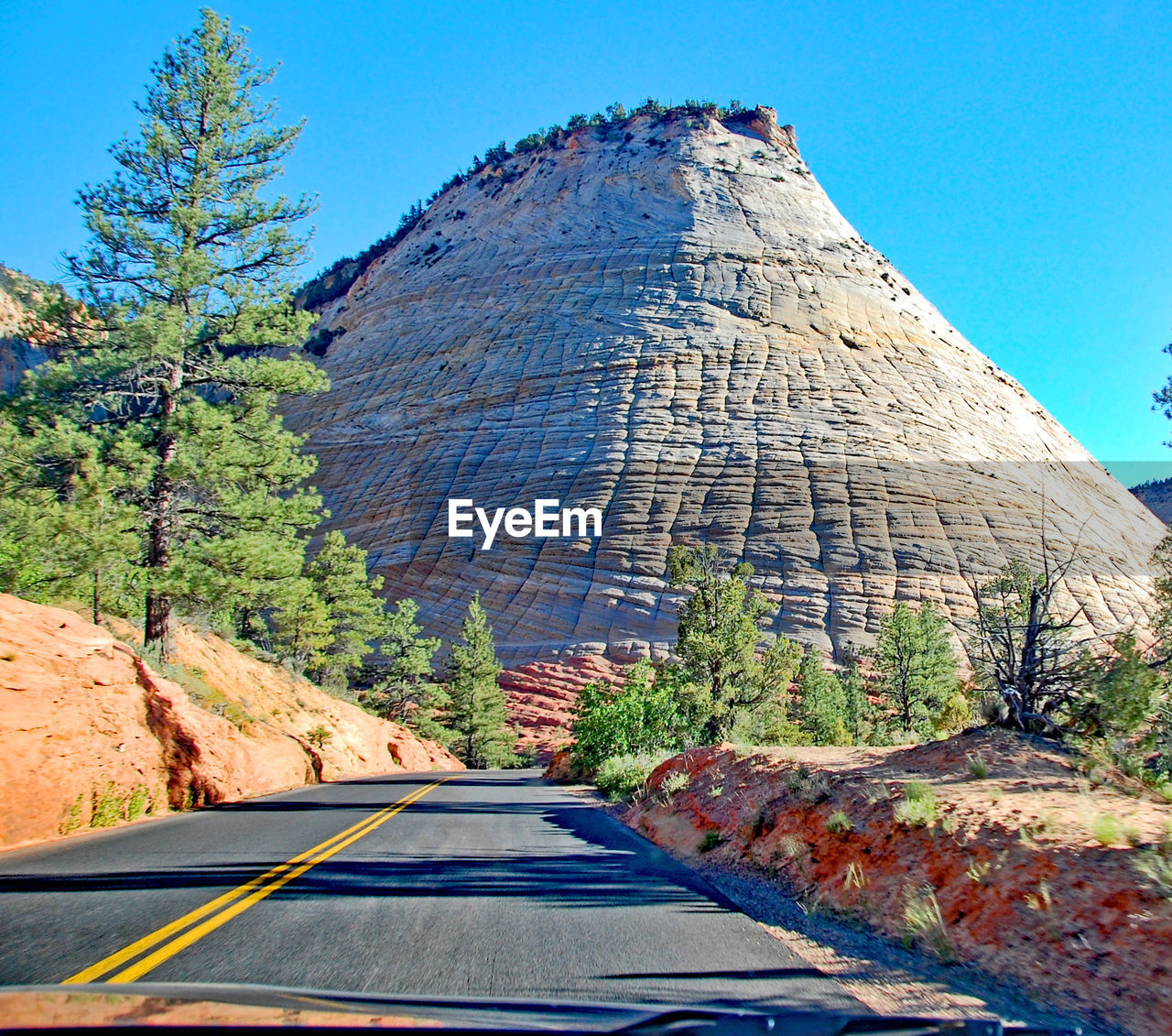 Empty road leading towards mountain