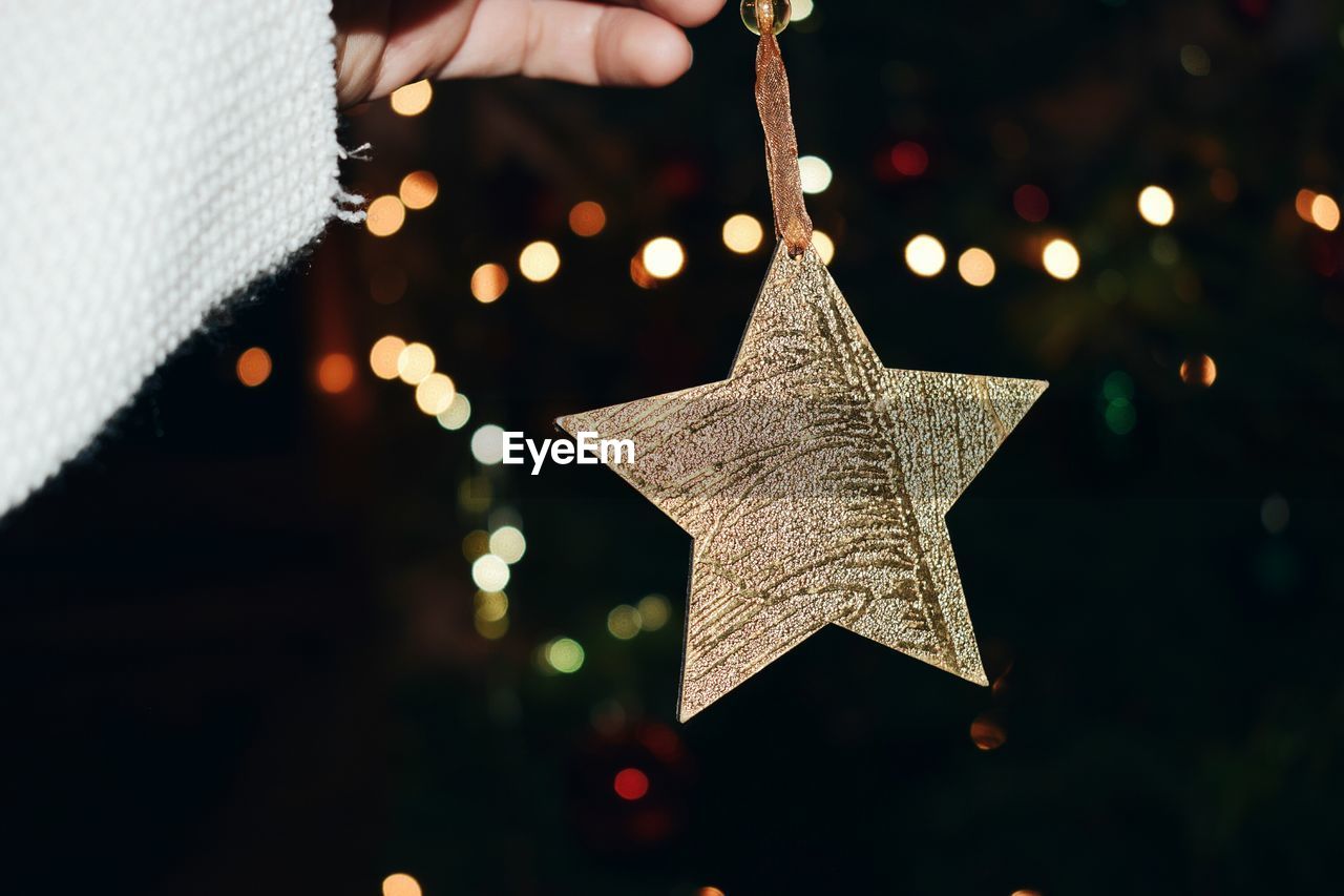 Close-up of person holding christmas decoration