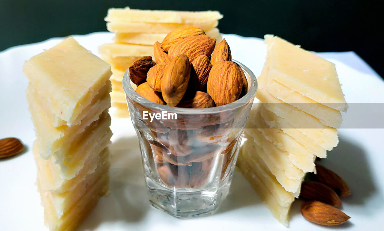 Badam katli is a diamond shape indian sweet with almonds  served in a plate 