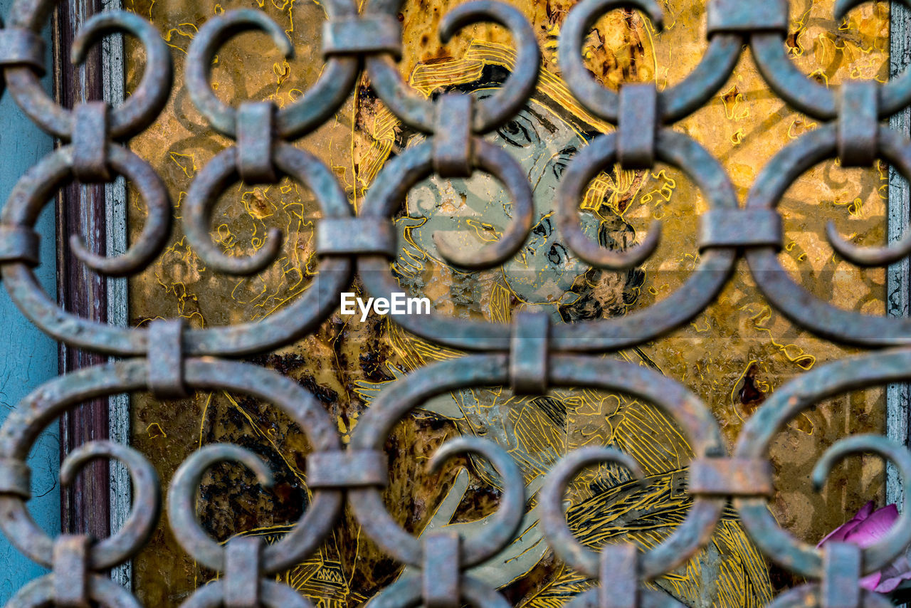 Full frame shot of decorative ironwork grill protecting religious shrine