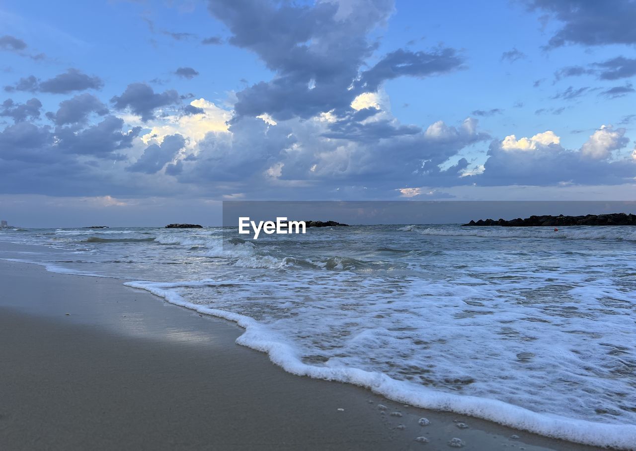 sea, water, land, beach, sky, body of water, cloud, wind wave, wave, scenics - nature, beauty in nature, horizon, shore, ocean, sand, nature, environment, coast, motion, travel destinations, landscape, travel, coastline, tranquility, sunset, horizon over water, sports, surfing, seascape, water sports, outdoors, tourism, trip, holiday, vacation, water's edge, tranquil scene, tide, blue, dramatic sky, sun, idyllic, summer, sunlight, tropical climate, dusk, day, island
