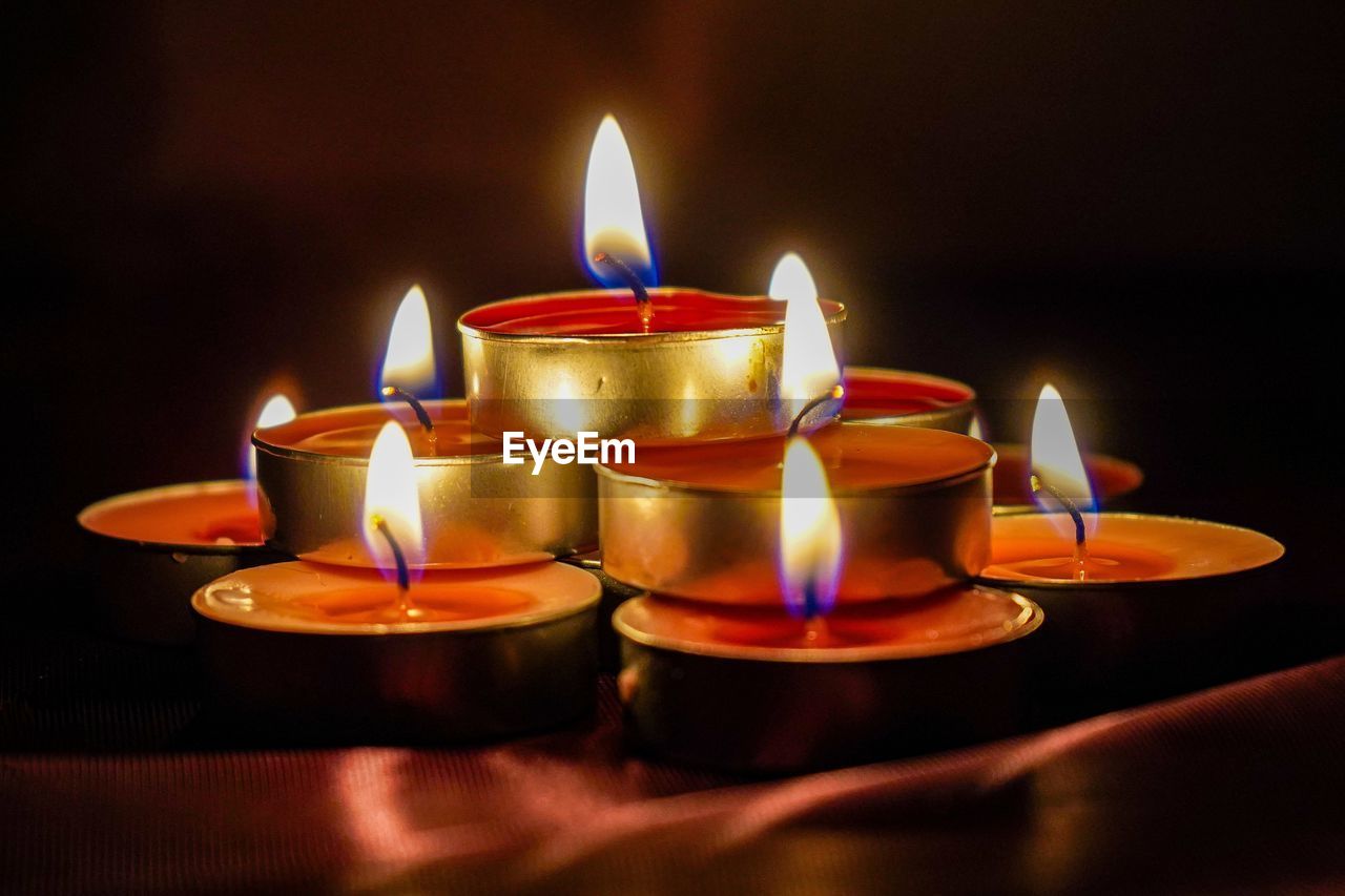 burning, fire, flame, candle, heat, illuminated, indoors, lighting, no people, nature, religion, close-up, glowing, spirituality, light, belief, celebration, interior design, dark, event, tradition, group of objects, lighting equipment