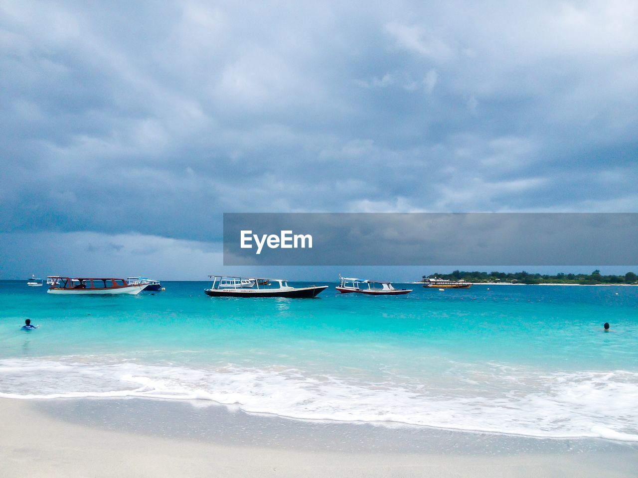 BOATS ON BEACH AGAINST SKY