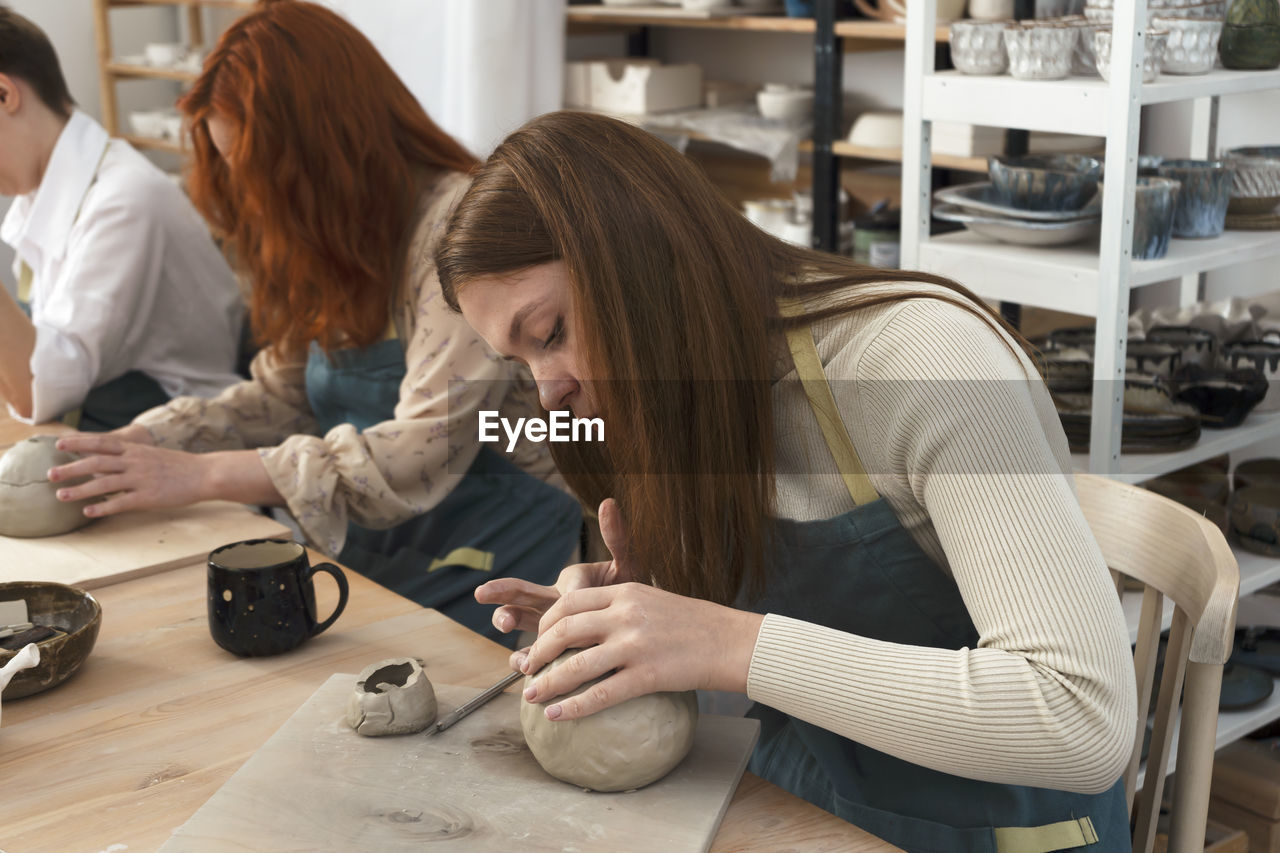 Pottery workshop class. a pottery crafts dish from a raw clay. creating ceramics