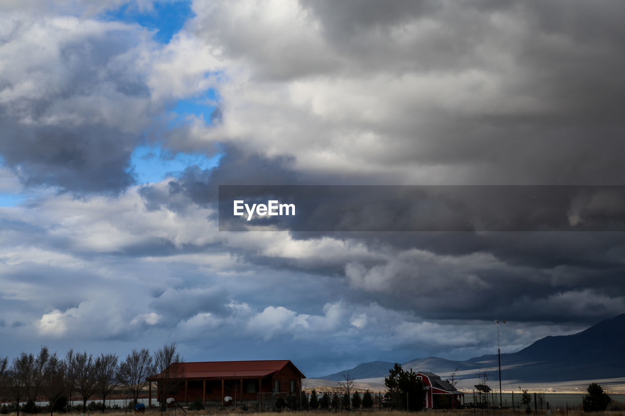 STORM CLOUDS OVER HOUSES