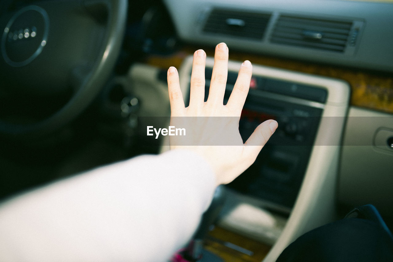 CLOSE-UP OF HAND TOUCHING MIRROR