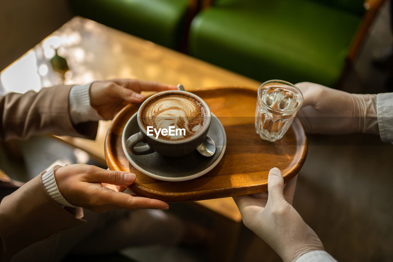 Midsection of woman holding coffee cup