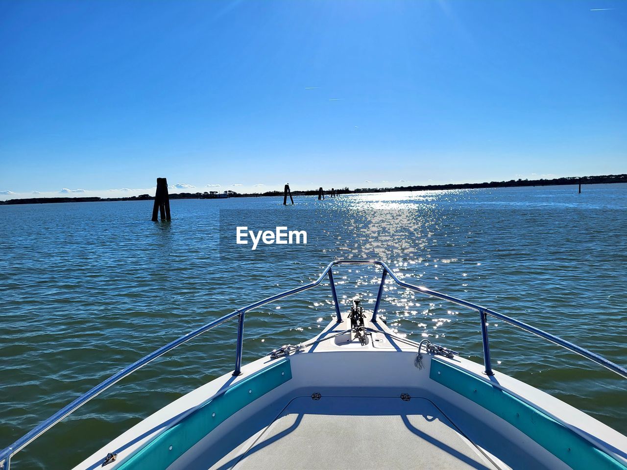 water, transportation, nautical vessel, sea, boat, sky, vehicle, nature, mode of transportation, blue, travel, clear sky, ship, sunlight, boating, holiday, day, vacation, beauty in nature, trip, sailing, outdoors, boat deck, scenics - nature, sunny, watercraft, deck, motion, copy space, railing, travel destinations, tranquility, luxury, summer, tranquil scene, yacht, no people, tourism, environment