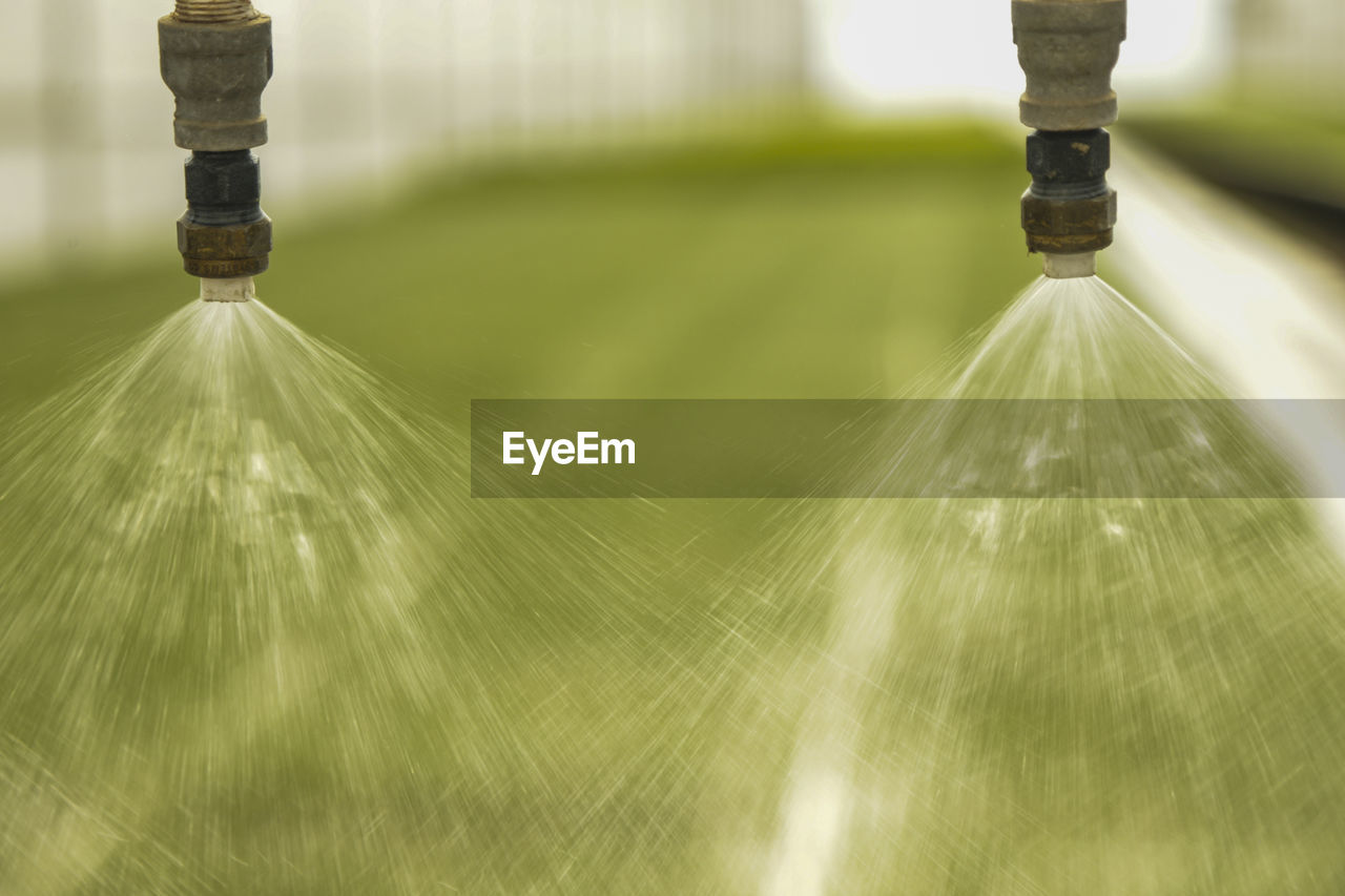 Close-up of sprinkler on field