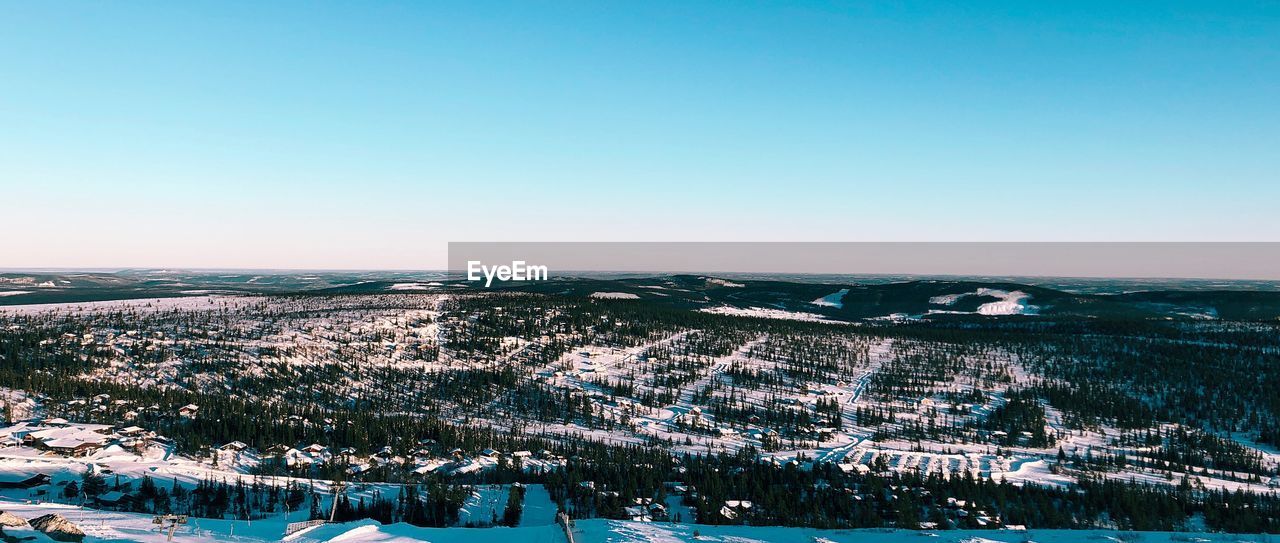 Aerial view of cityscape against clear sky during winter