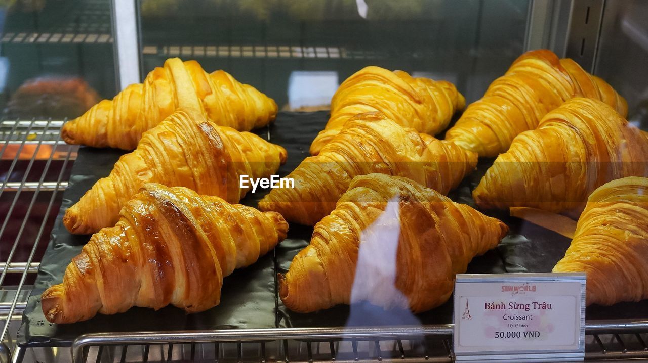 food, food and drink, freshness, fast food, croissant, baked, store, retail, no people, dessert, bakery, business, french food, sweet food, pastry, business finance and industry, in a row, dish, for sale, close-up, large group of objects, still life, snack, indoors, cuisine, bread, baked pastry item, viennoiserie, healthy eating, abundance, meal, market, retail display