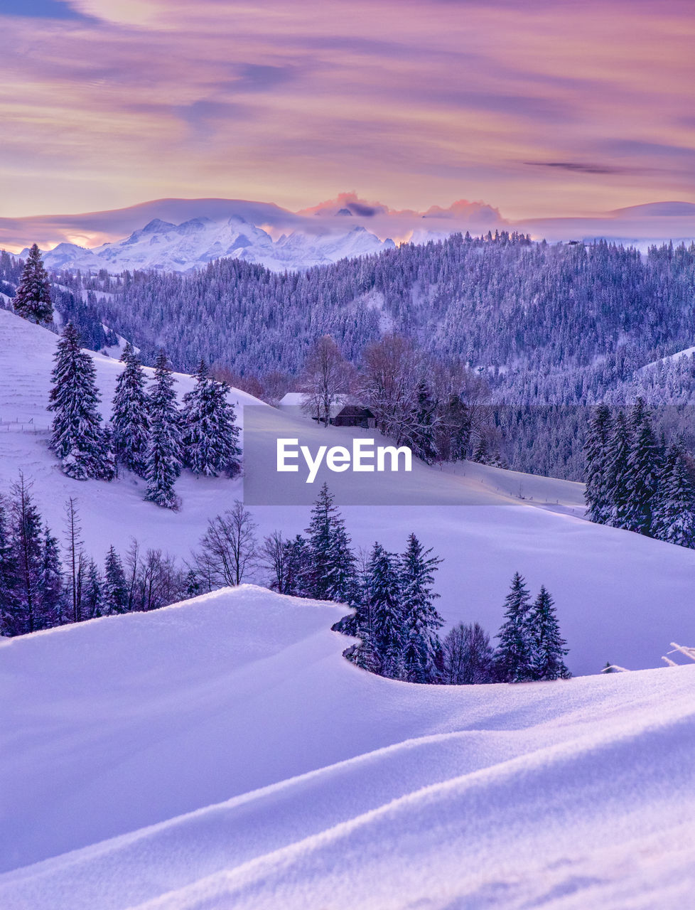 Scenic view of snow covered mountains against sky