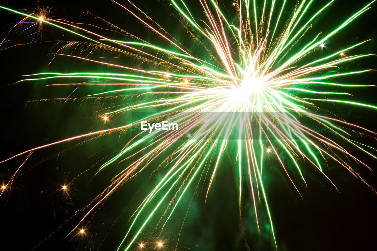 LOW ANGLE VIEW OF FIREWORKS IN SKY