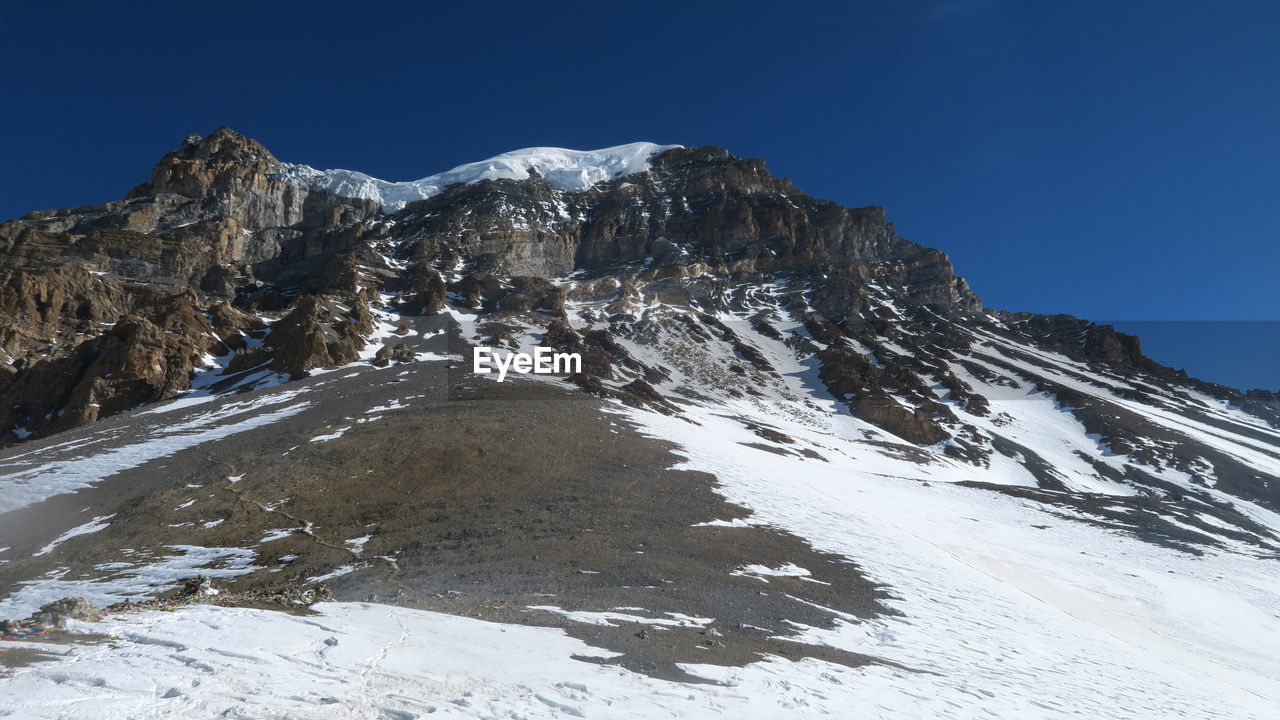 Scenic view of snowcapped mountains against clear sky