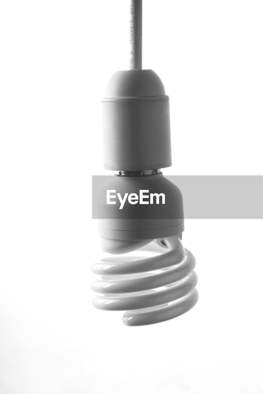 Close up of energy efficient lightbulb against white background