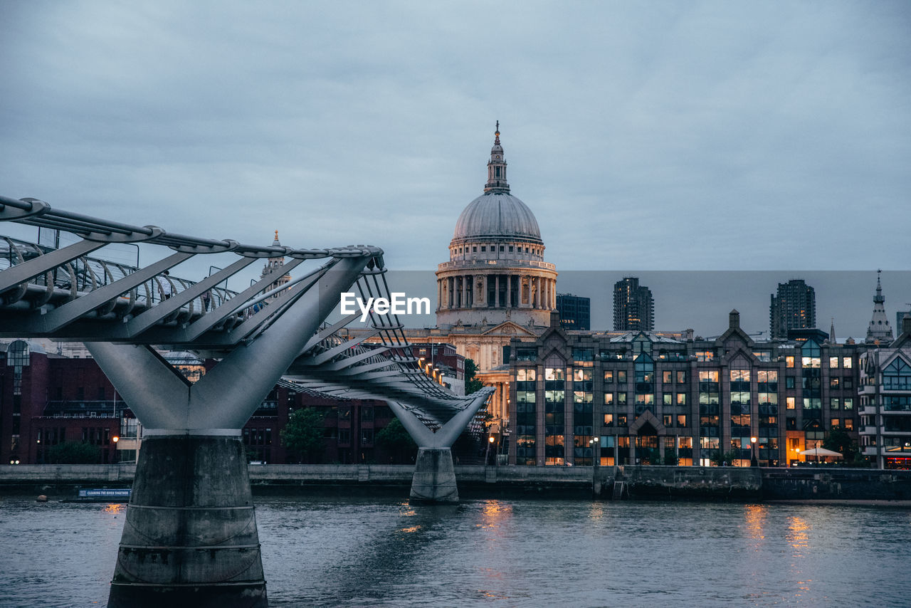 VIEW OF BRIDGE OVER RIVER AGAINST CITYSCAPE