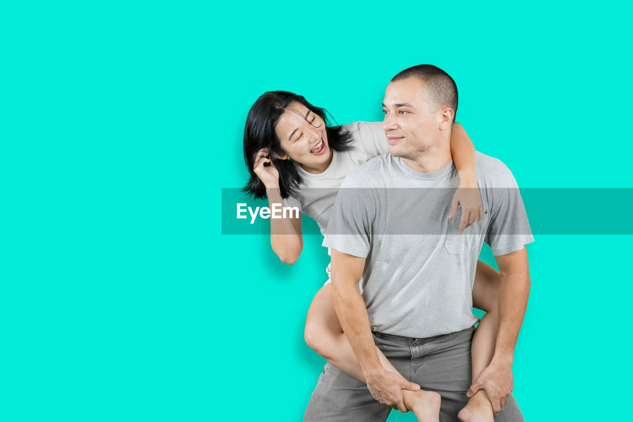 YOUNG COUPLE AGAINST WHITE BACKGROUND