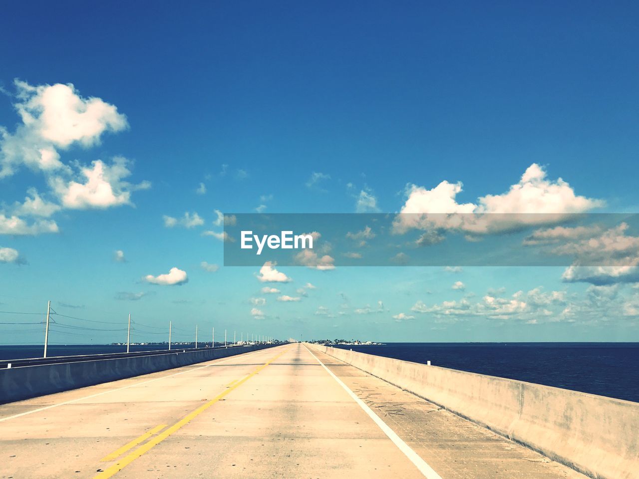 View of bridge over sea against blue sky