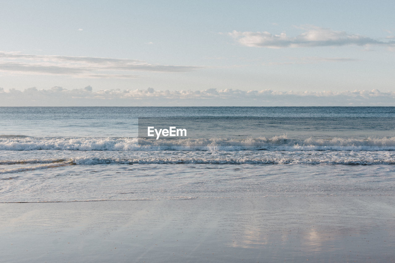 sea, water, sky, land, scenics - nature, beauty in nature, beach, horizon, shore, cloud, nature, wave, ocean, body of water, tranquility, horizon over water, wind wave, winter, ice, no people, motion, tranquil scene, environment, sand, morning, outdoors, idyllic, reflection, snow, freezing, landscape, day, coast, seascape, travel, travel destinations, blue, sunlight, non-urban scene