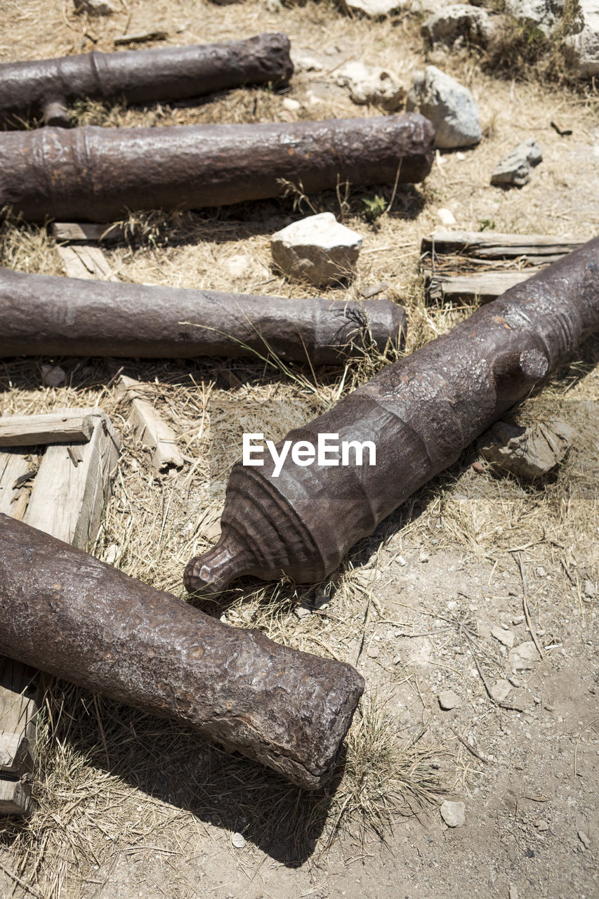 High angle view of wood and stones on field