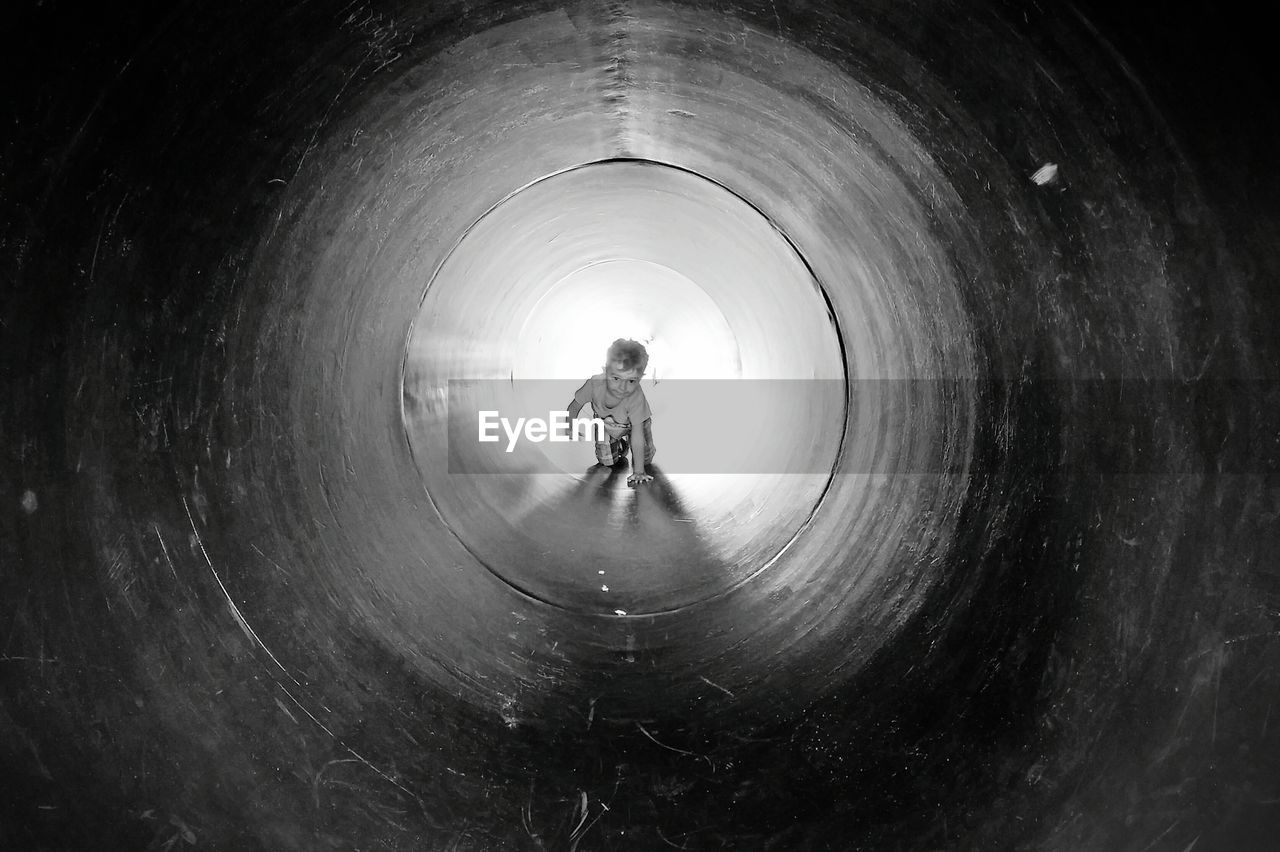 Toddler crawling in pipe