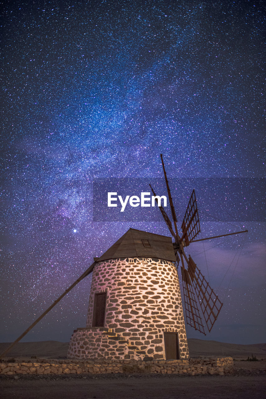 LOW ANGLE VIEW OF TRADITIONAL WINDMILL AGAINST SKY