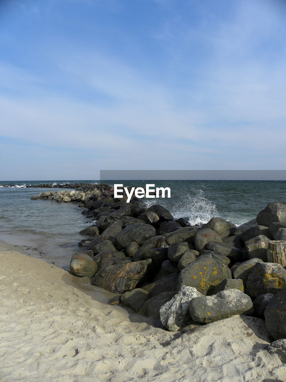 ROCKS ON SHORE AGAINST SKY