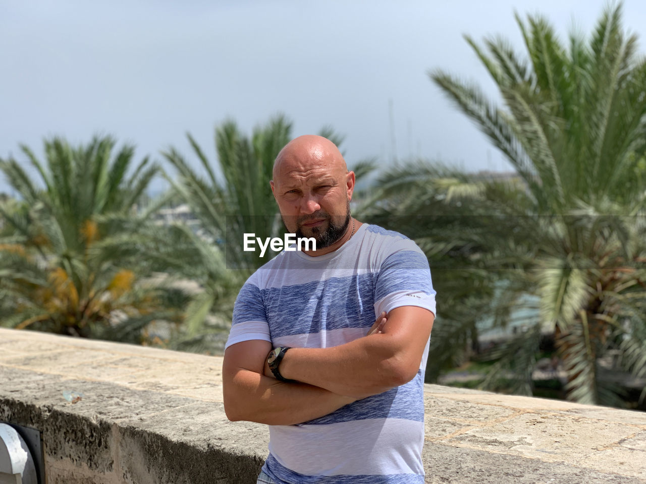 MAN STANDING AGAINST PLANTS