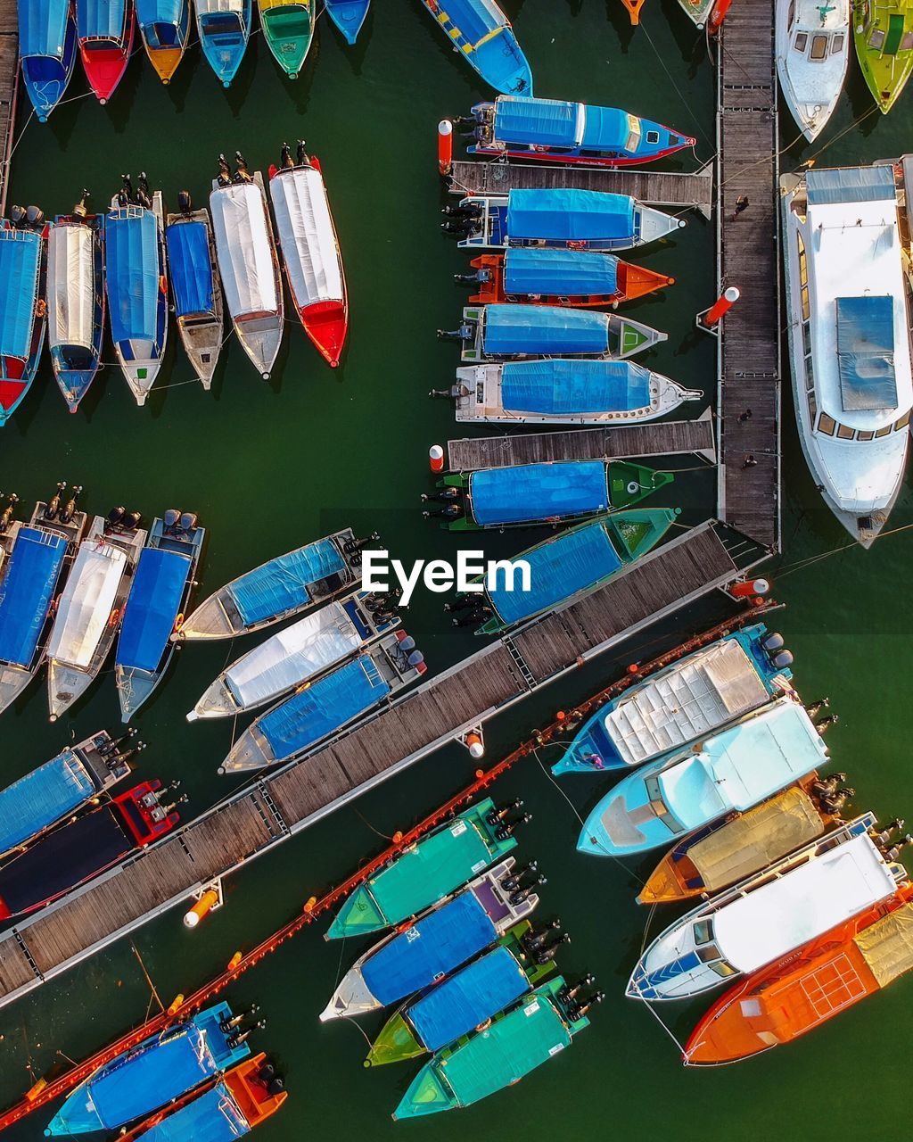 High angle view of multi colored boats moored at harbor in lake