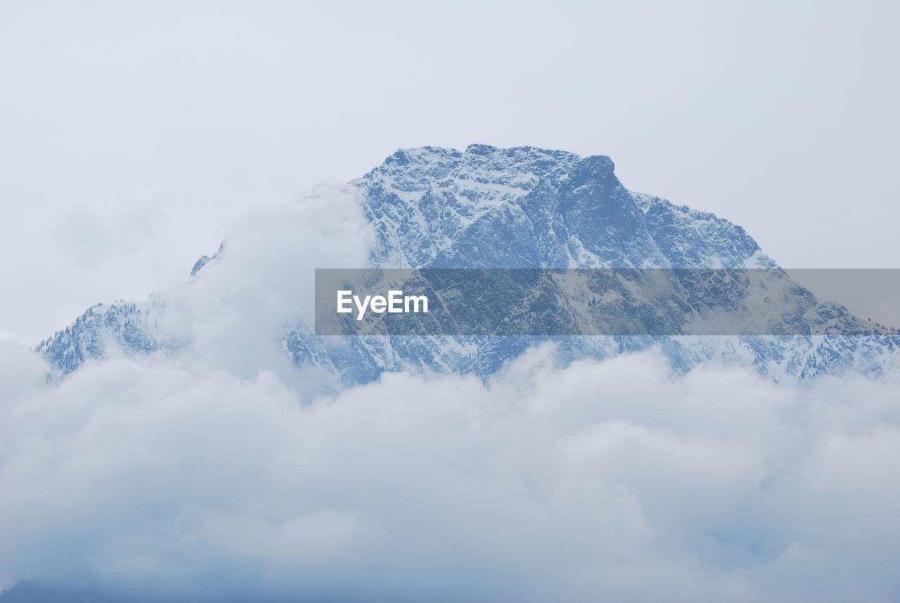 Low angle view of snowcapped mountain against sky