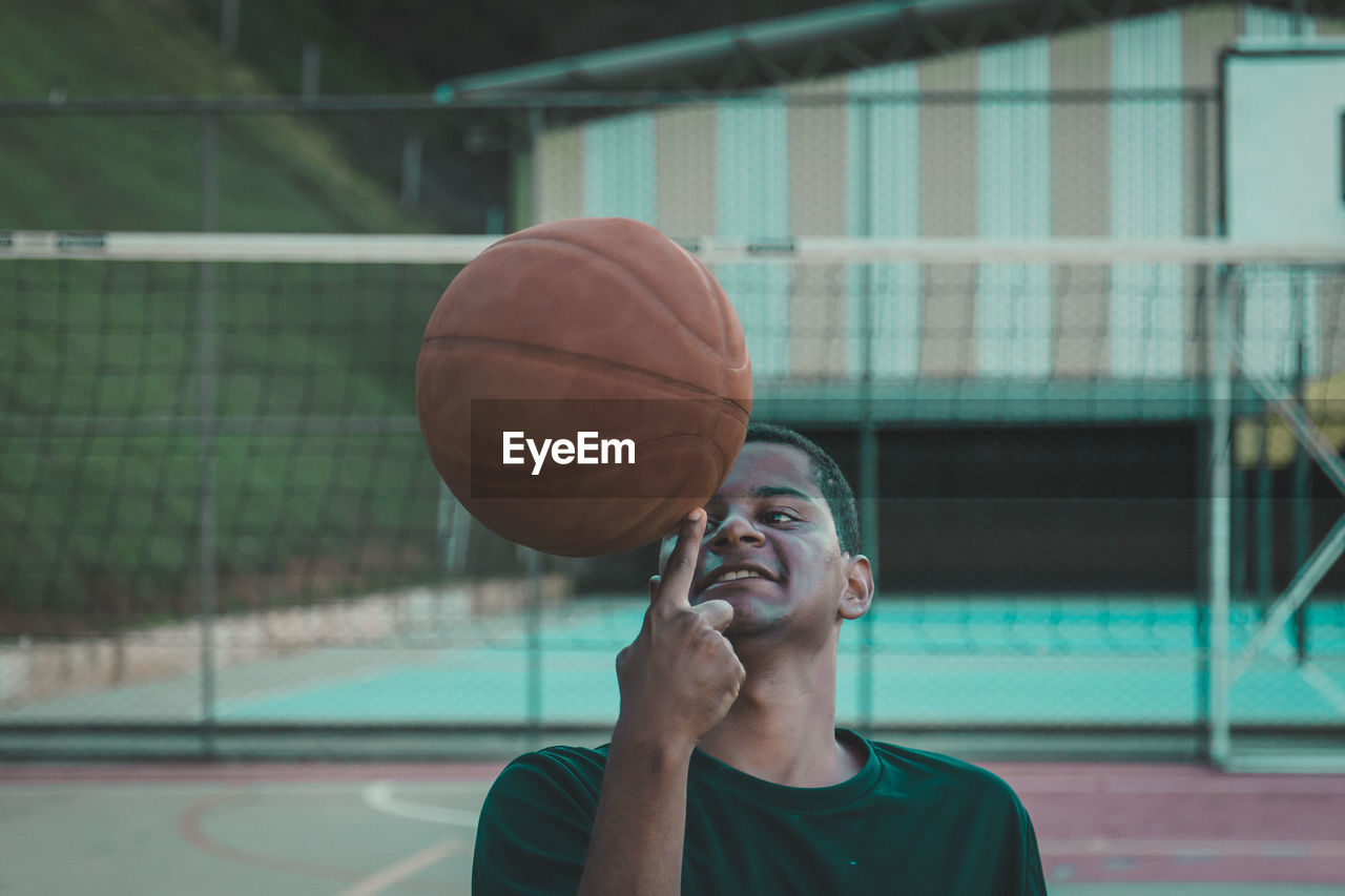 Close-up of man with basketball