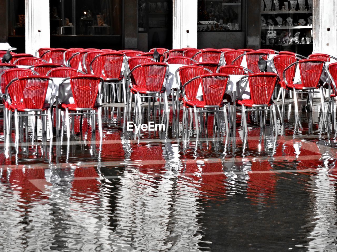 Empty red chairs with waterfront