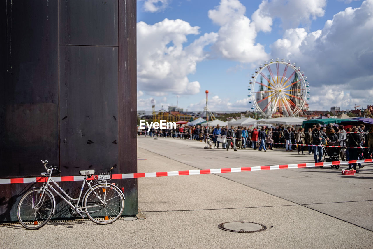 Crowd on street by amusement park
