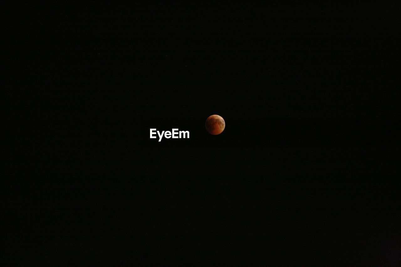 LOW ANGLE VIEW OF MOON AGAINST CLEAR SKY