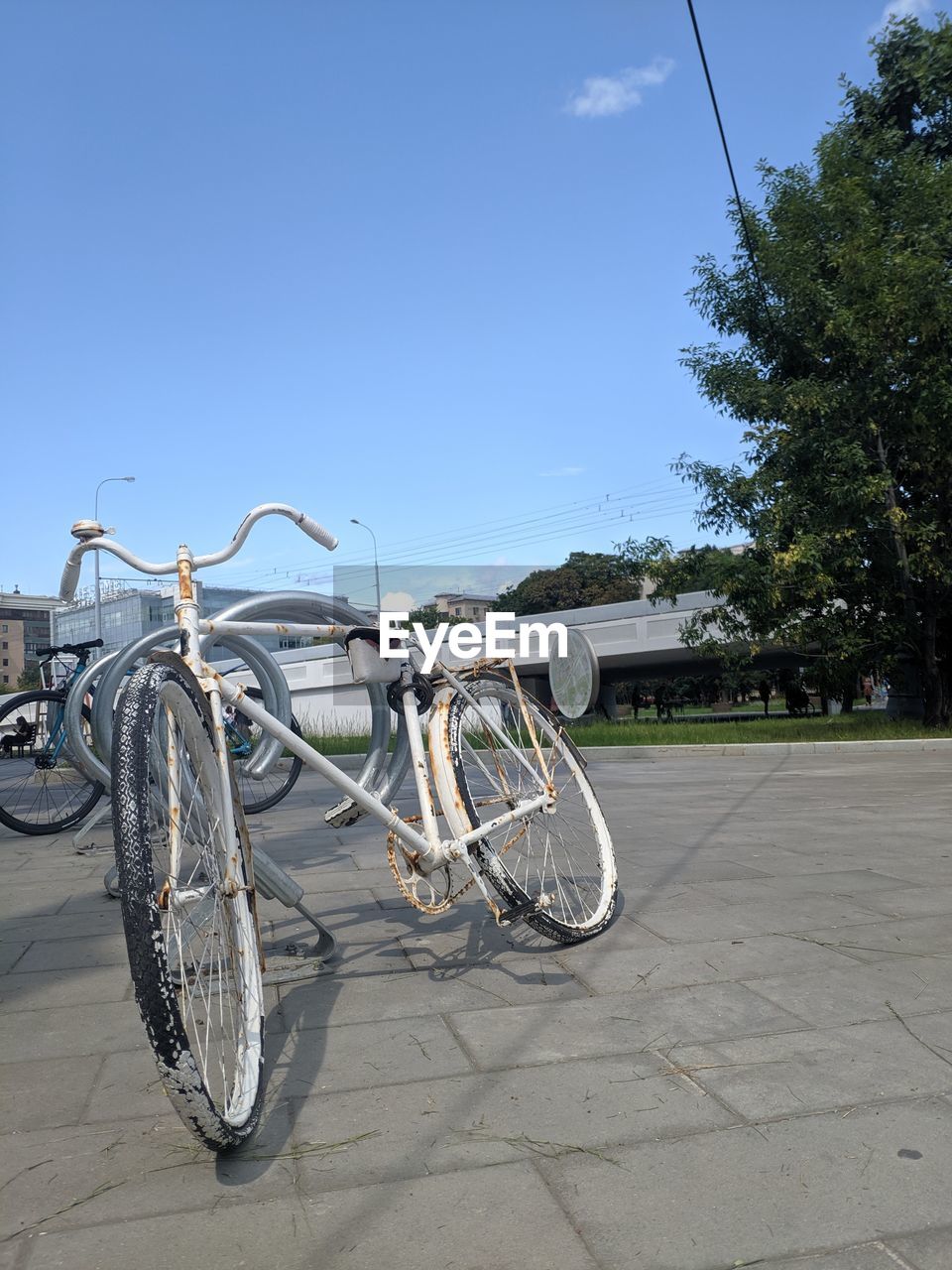 BICYCLES PARKED ON FOOTPATH AGAINST SKY