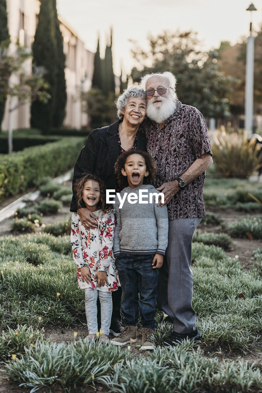 Traditional portrait of grandparents and grandchildren standing