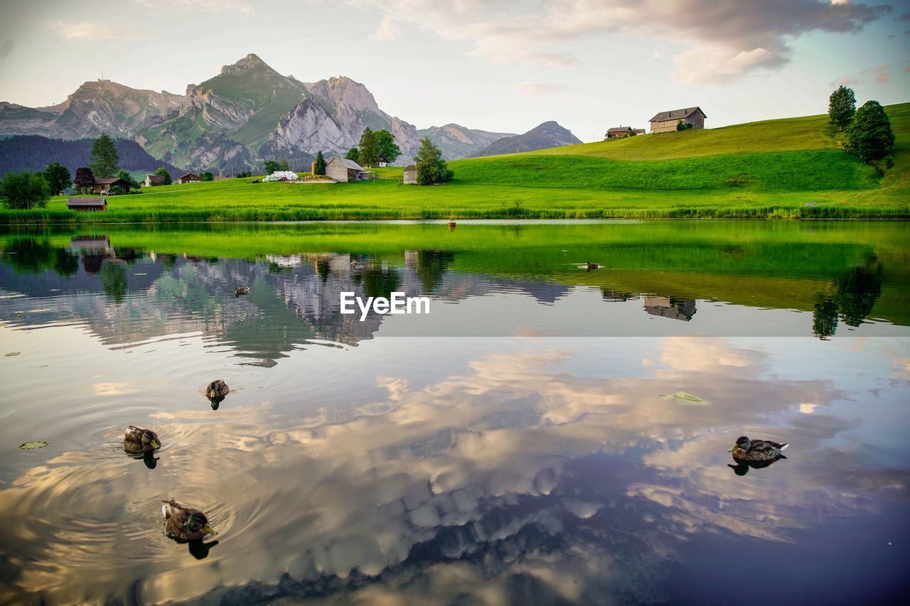 SCENIC VIEW OF LAKE AND MOUNTAIN RANGE