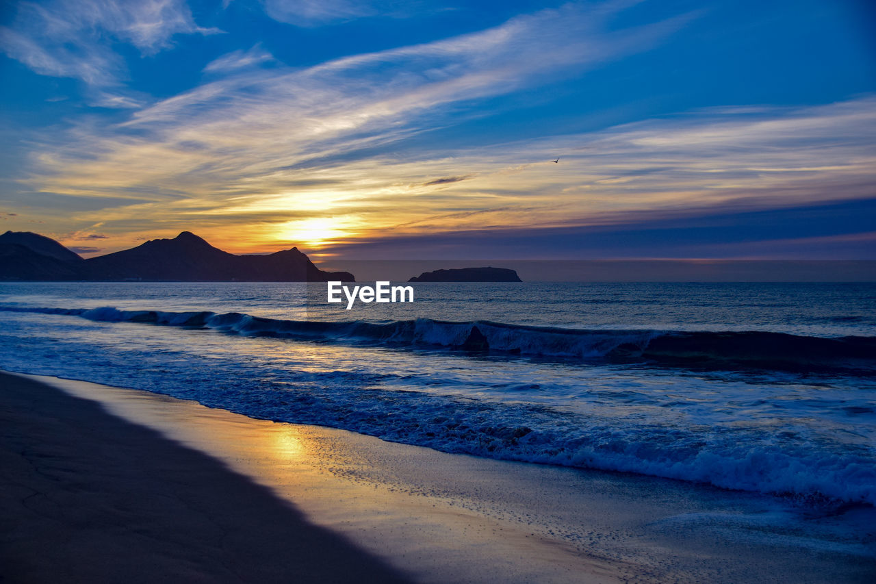 Sunrise over the headland east of vila baleira, porto santo island, madeira, portugal