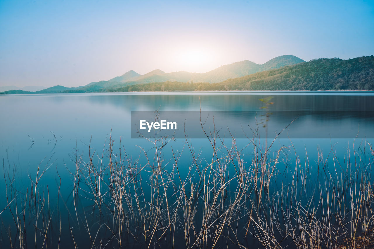 Scenic view of lake against blue sky during sunset