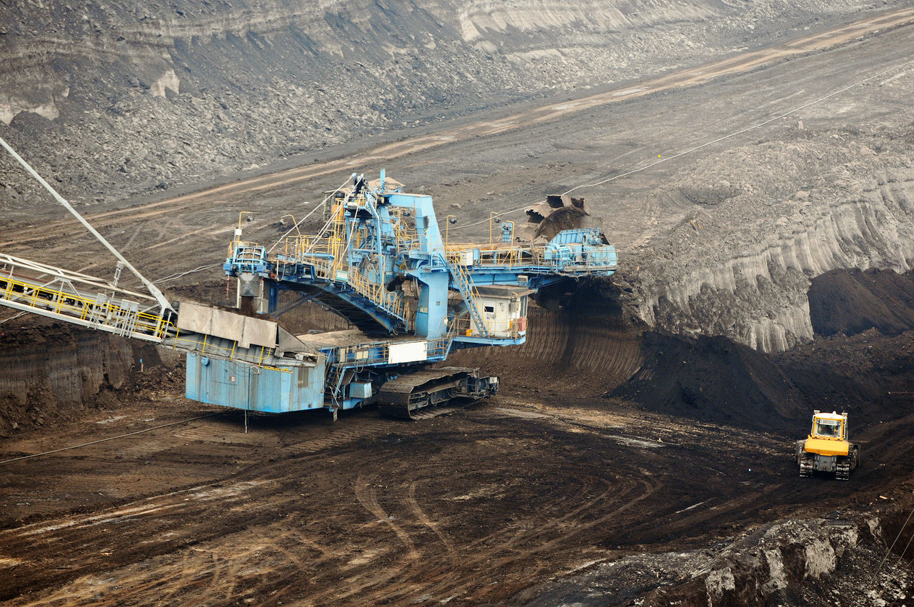 HIGH ANGLE VIEW OF MACHINE PART AND CARS