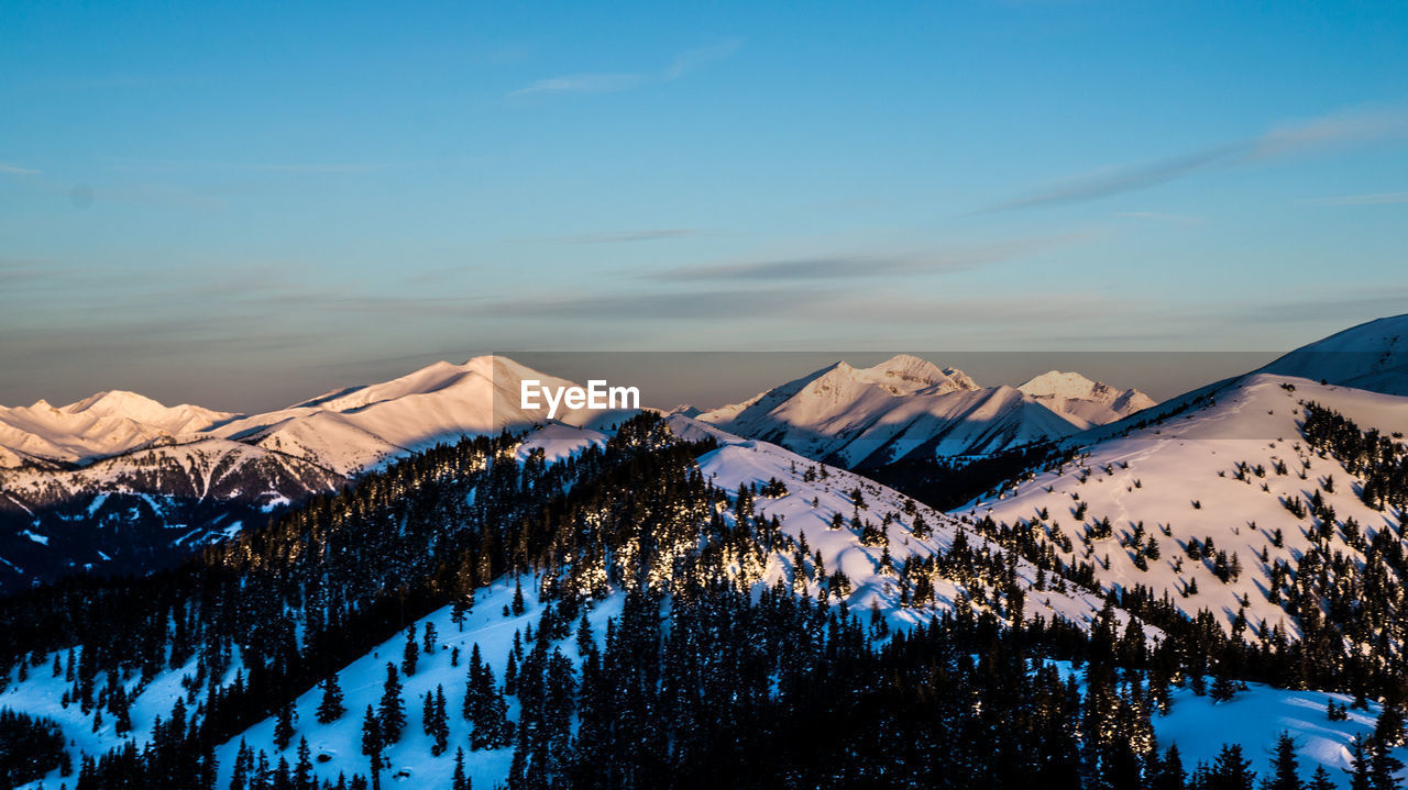 Scenic view of snowcapped mountains against sky during winter