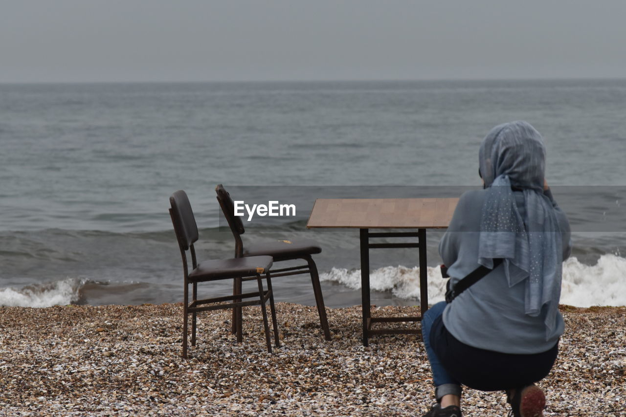 Rear view of woman looking at sea shore