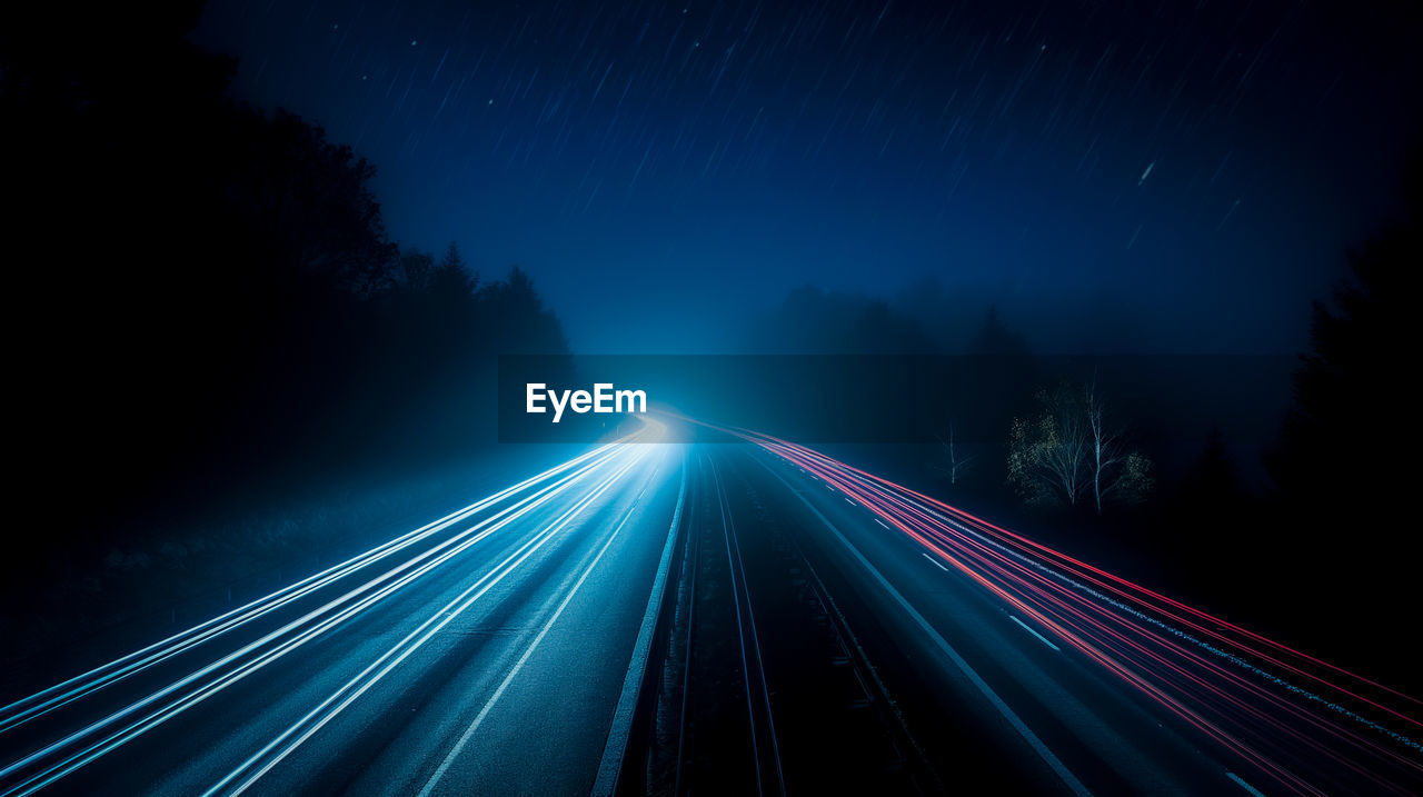 High angle view of light trails on road at night