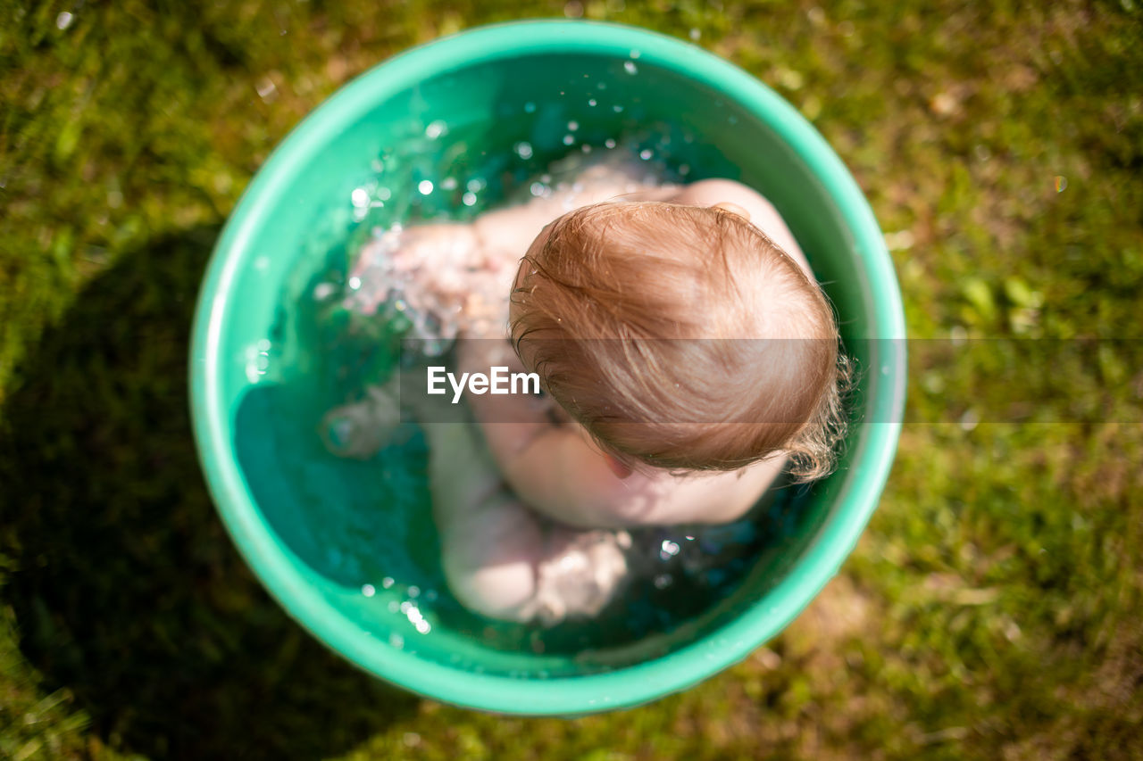 High angle view of child in container