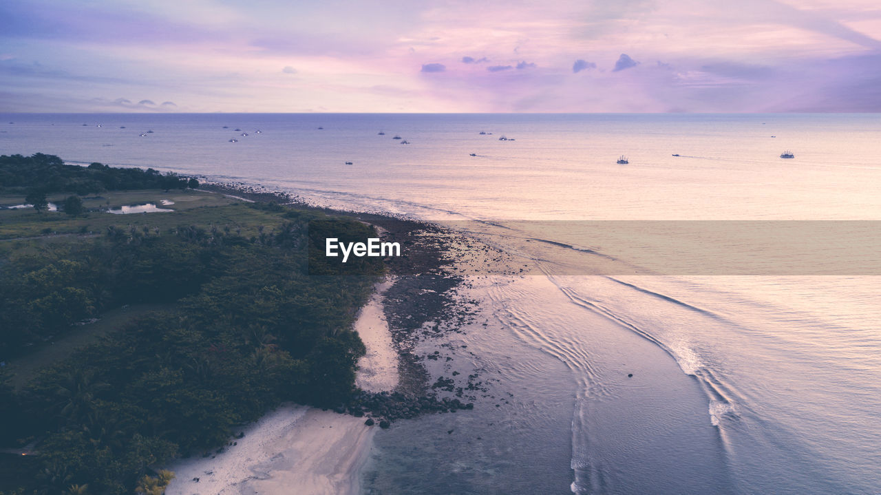 SCENIC VIEW OF BEACH DURING SUNSET